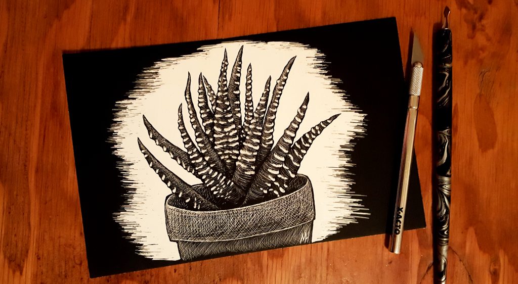 Starting an Art Business Zebra Plant Scratchboard with an Xacto knife and scratch on the right. Background is reddish-brown wood.
